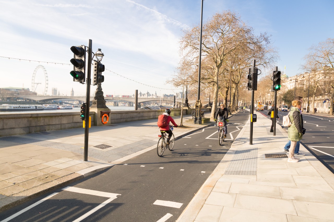 Cyclists in a cycle lane alongside the River Thames