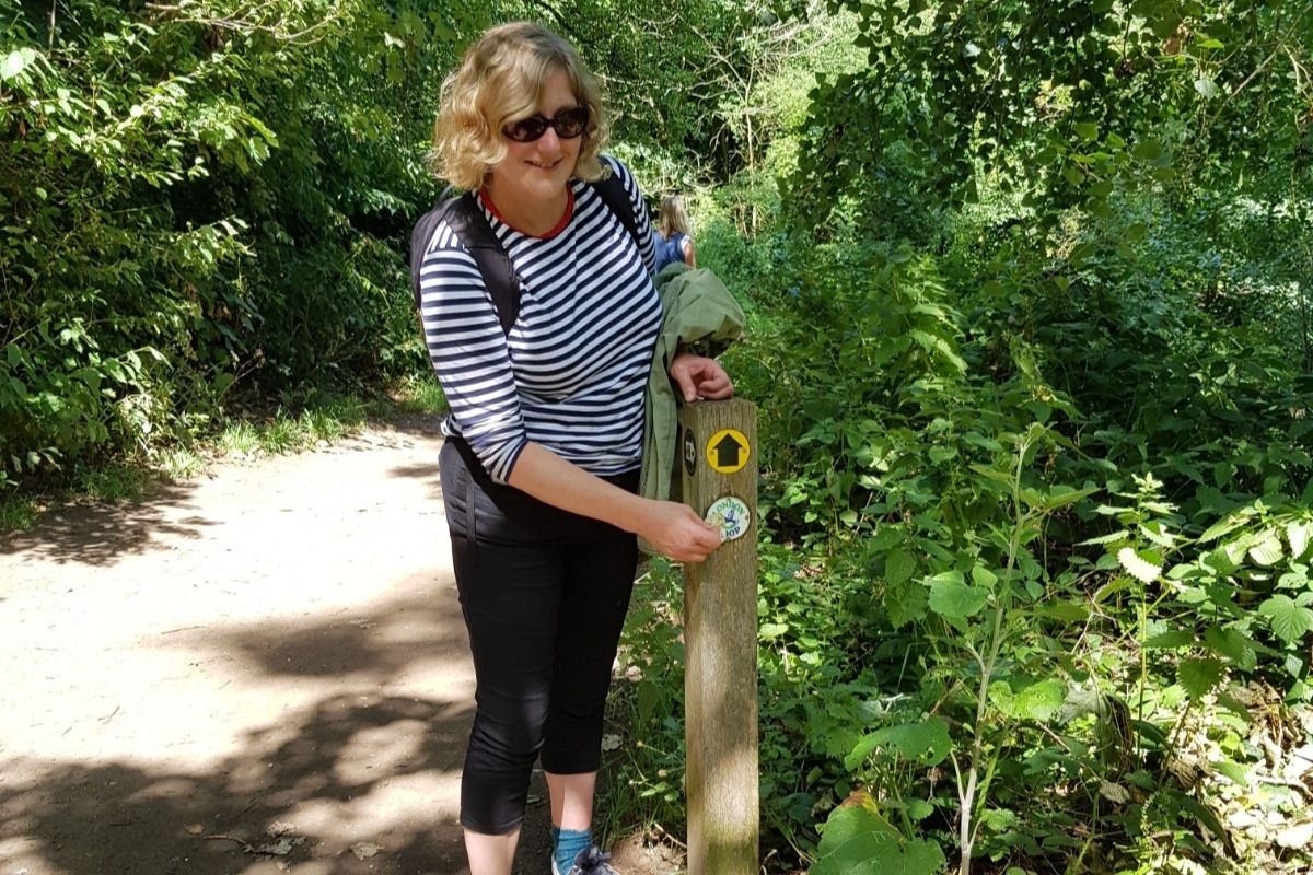 clare next to walking route post